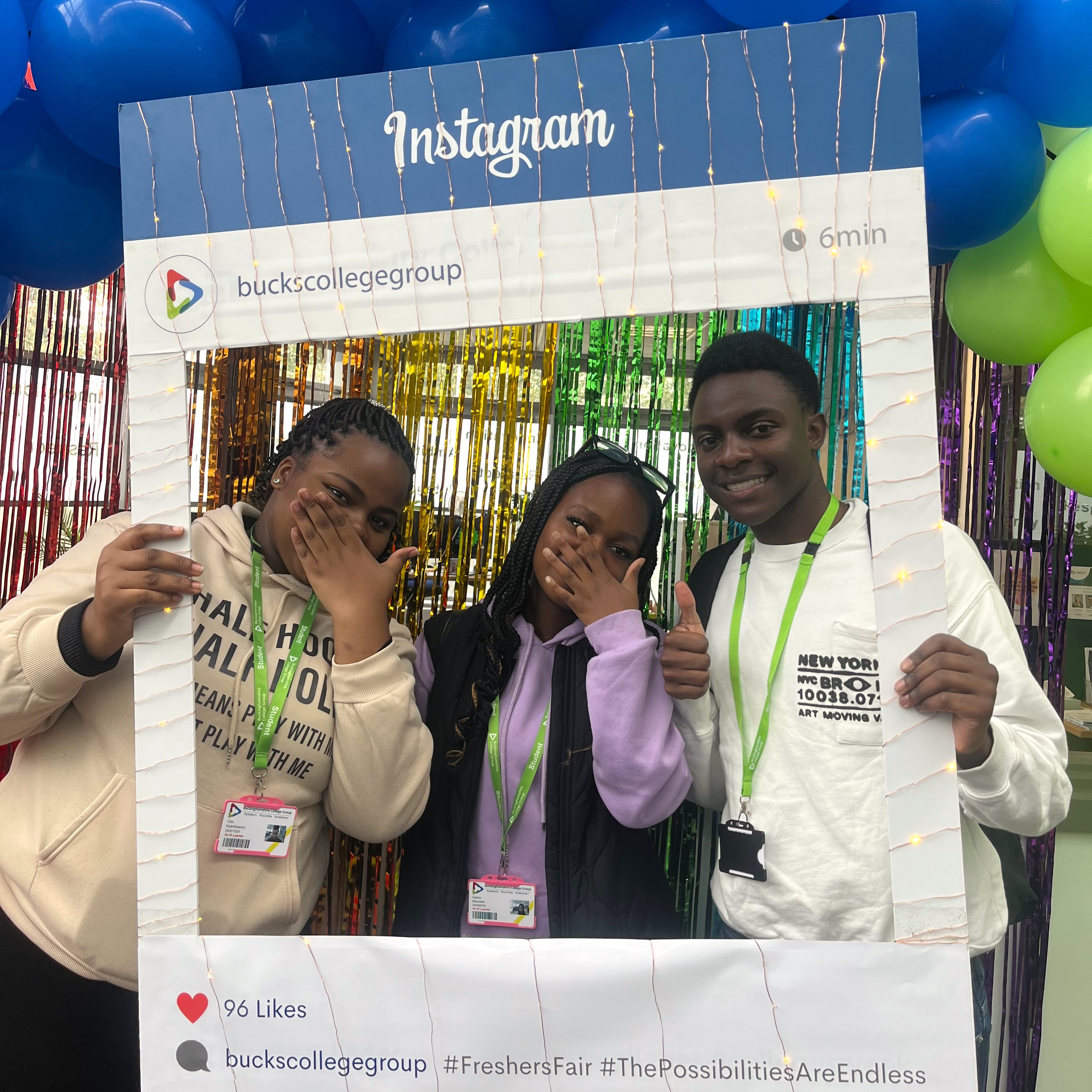 Three students holding an Instagram selfie frame at the Aylesbury Freshers Fair