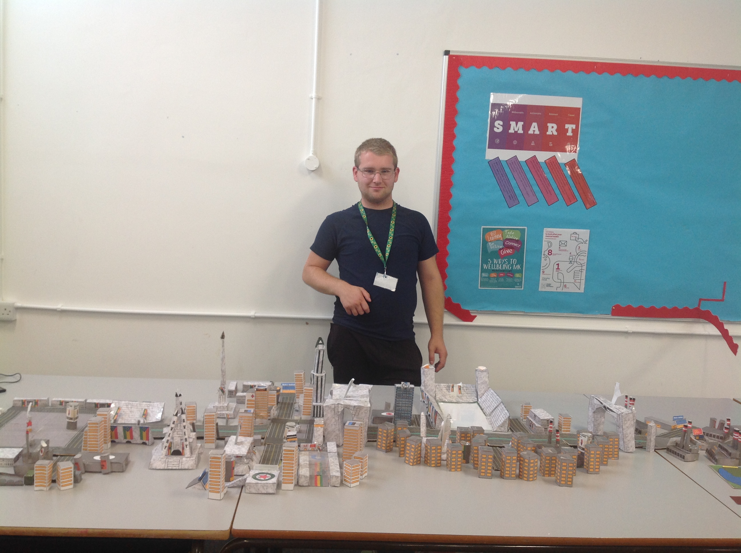 Declan standing with his model city