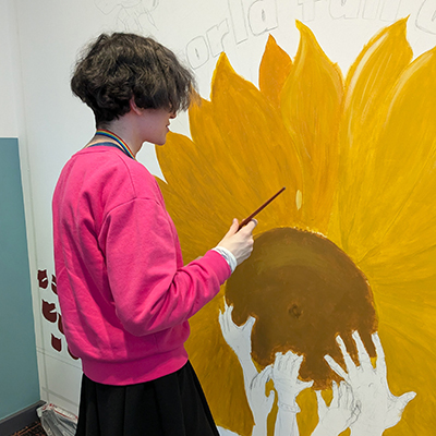 Student Starting to Paint Mural