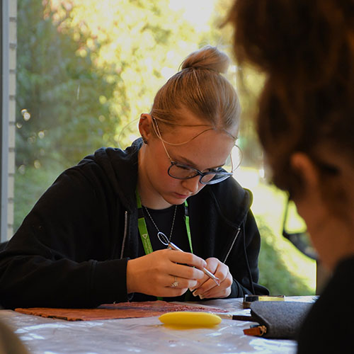 Student Sculpting On Clay Board