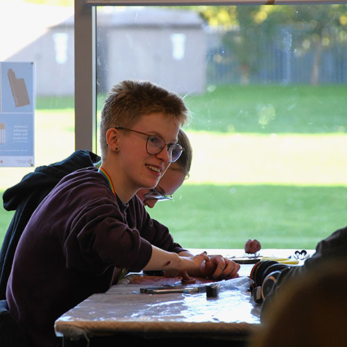 Student Smiling While Sculpting