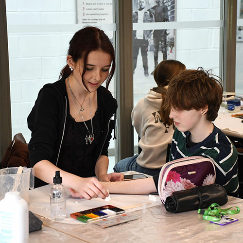 Two Students Painting Burn Effects